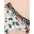 Leopard print thong underwear and floral patterned thong underwear displayed on a pink surface