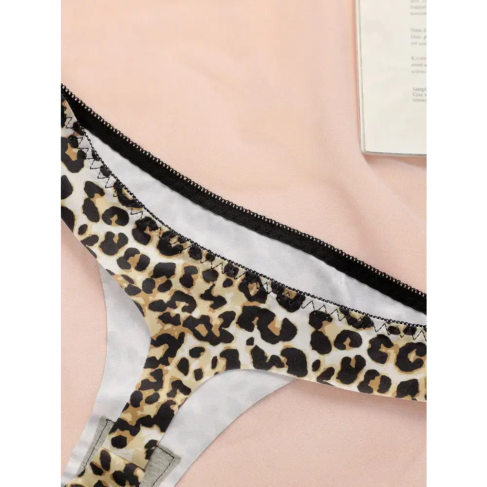 Leopard print thong underwear from The Lady's Haven Boutique with black trim on pink background