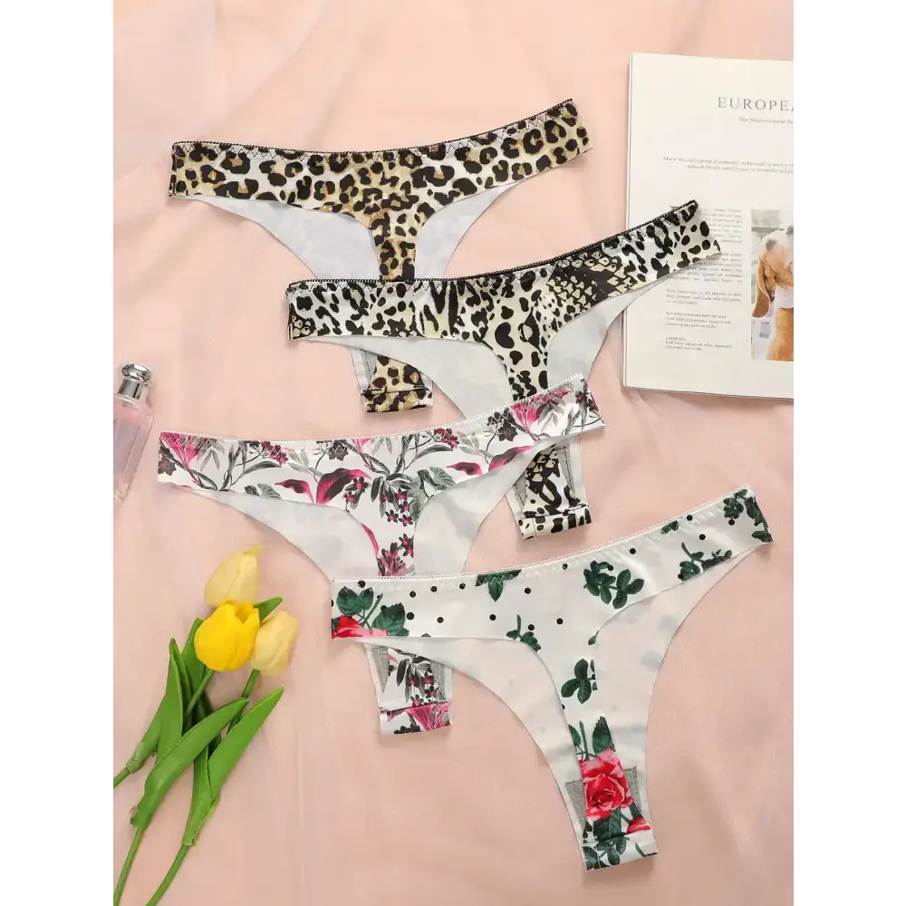 Set of leopard print thong underwear and floral thong underwear laid out on pink background