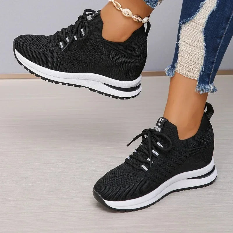 Black lightweight walking shoes with white soles from The Lady's Haven Boutique worn with ripped jeans