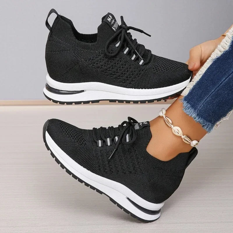 Black lightweight walking shoes with knitted upper and white sole from The Lady's Haven Boutique