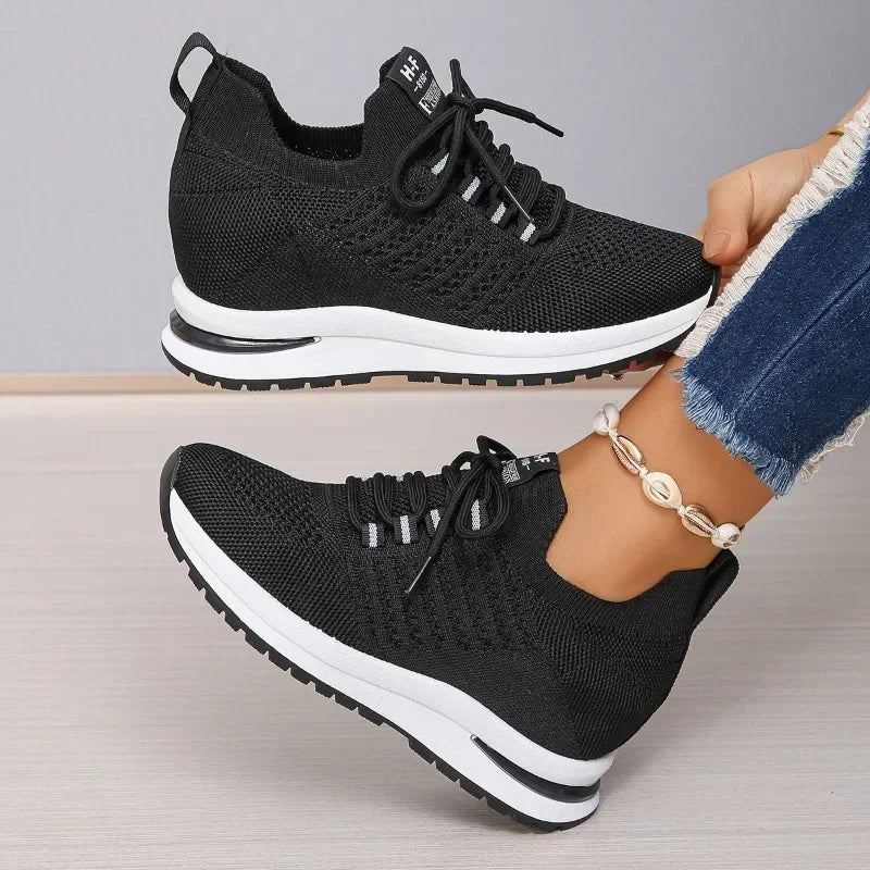 Black lightweight walking shoes with white soles from The Lady's Haven Boutique worn with blue jeans
