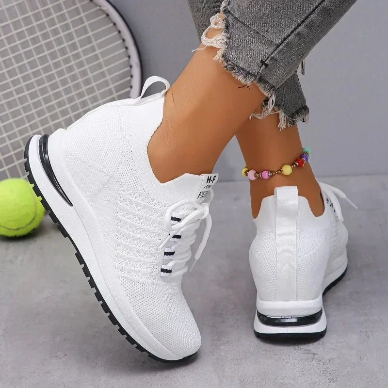 White lightweight walking shoes from The Lady's Haven Boutique worn with gray distressed jeans