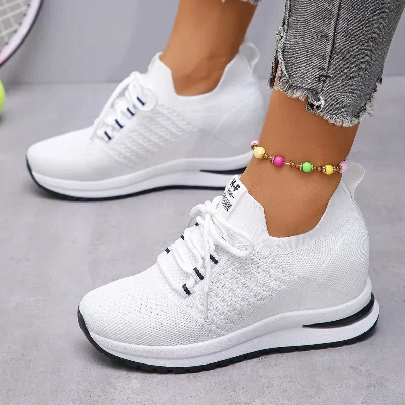 White lightweight walking shoes with knit upper and cushioned sole from The Lady's Haven Boutique