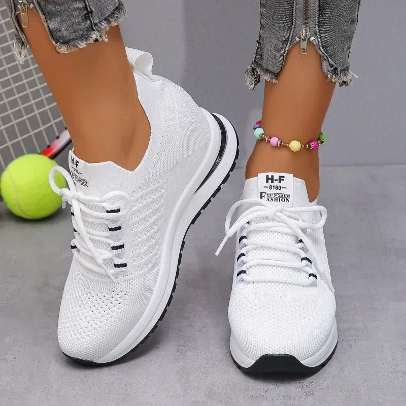 White lightweight walking shoes from The Lady's Haven Boutique with knit upper and black sole