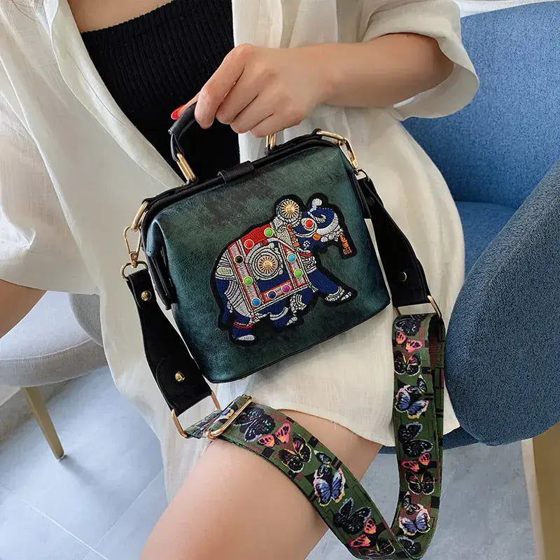 Luxury embroidered crossbody bag featuring an elephant design and a decorative strap for trendy style