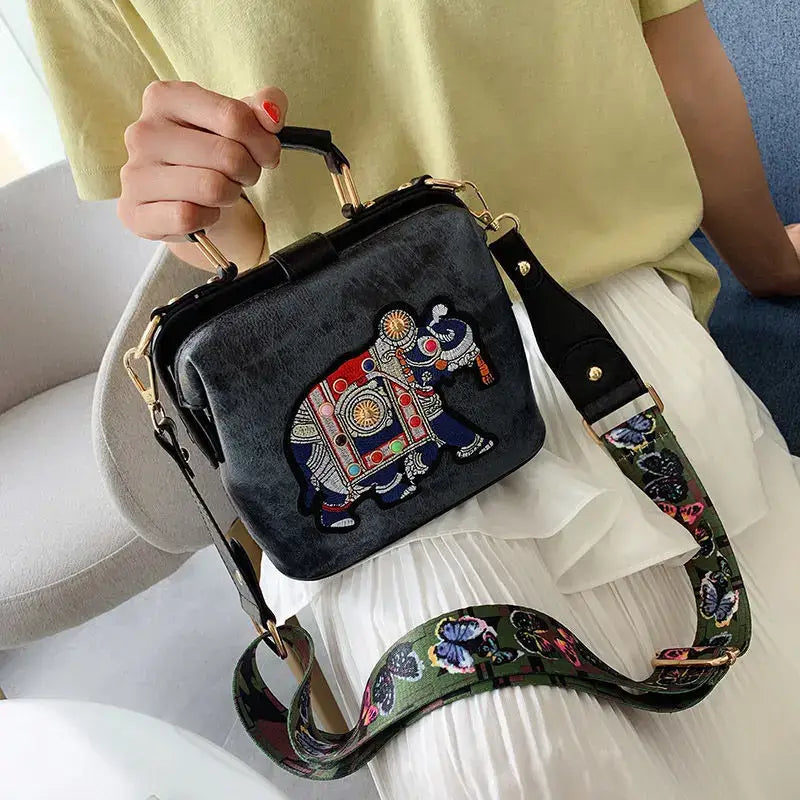 Luxury embroidered crossbody bag featuring a colorful elephant design with a stylish strap