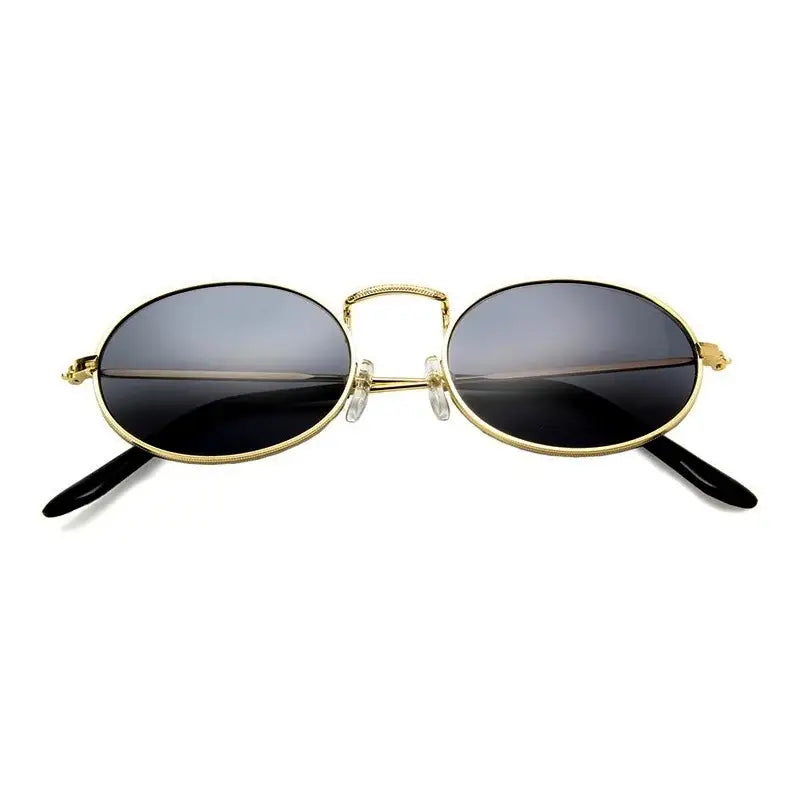 Elegant luxury oval sunglasses women with gold frame and dark lenses for stylish sun protection