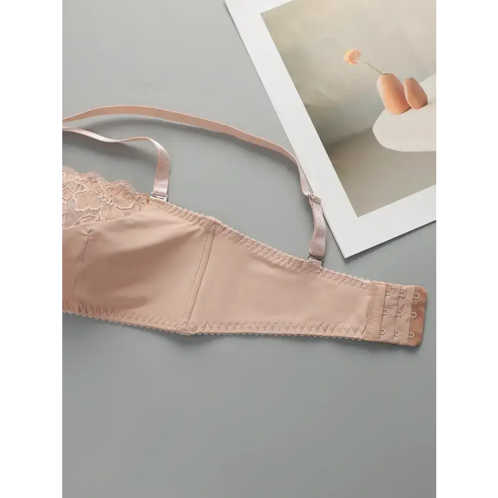 Beige wire support bra and panty set featuring adjustable straps and hook closures
