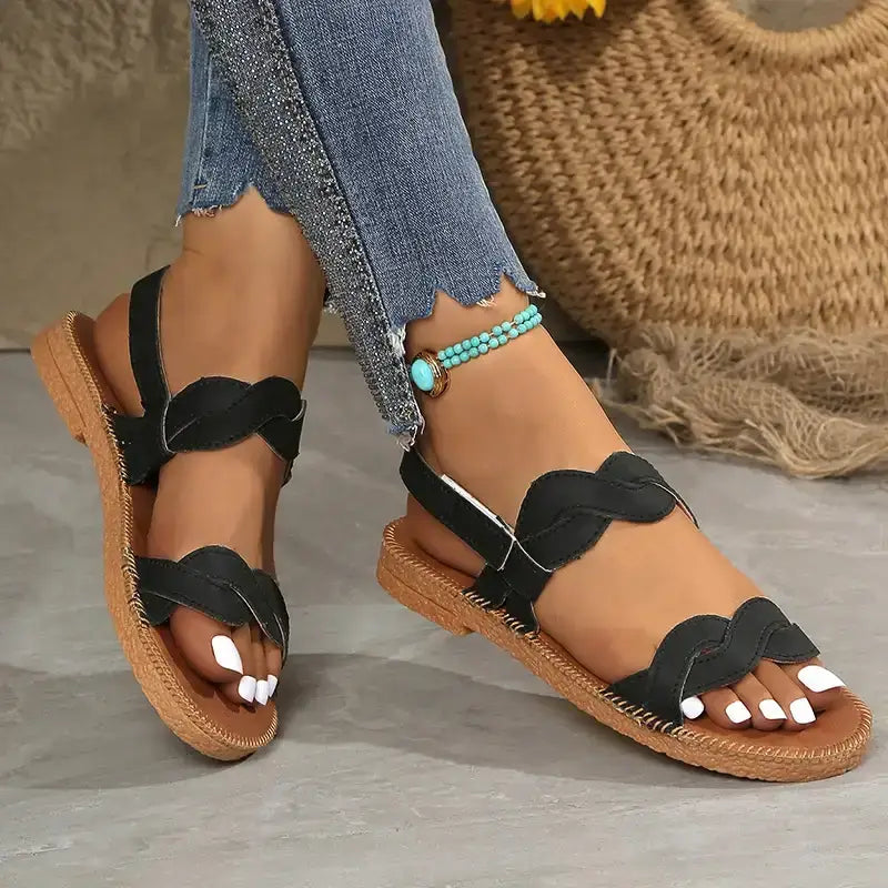 Non slip flat heel summer sandals in black with braided straps and tan sole from The Lady's Haven Boutique