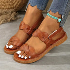 The Lady's Haven Boutique brown non slip flat heel summer sandals with braided straps on feet