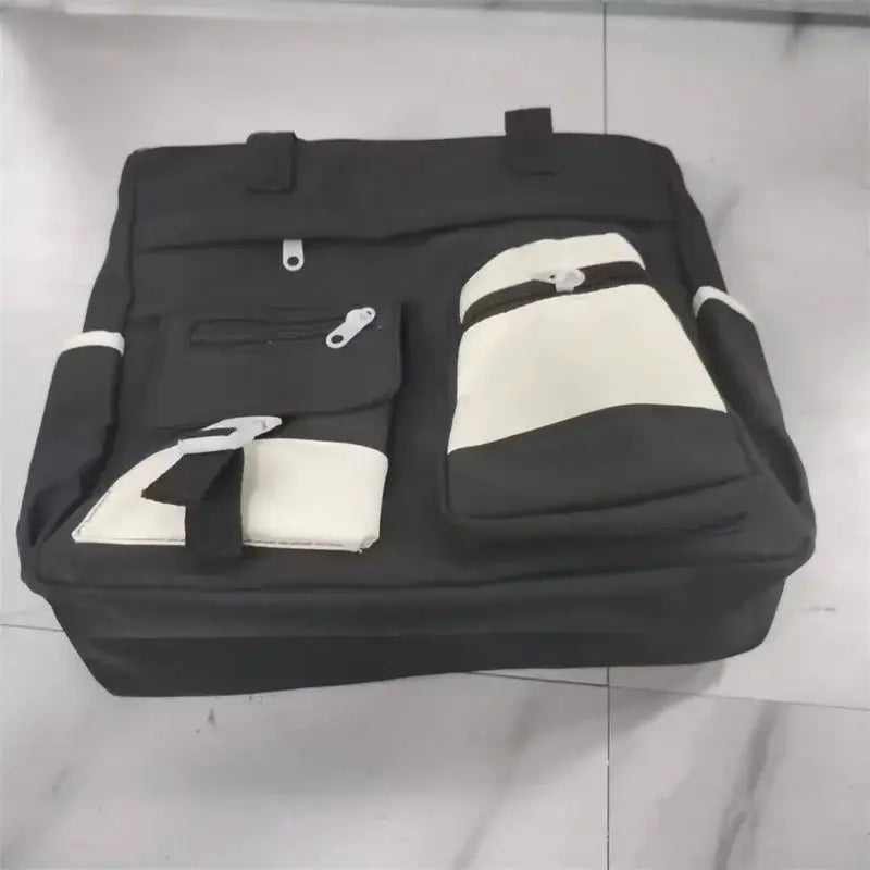 Black and cream nylon crossbody messenger bag with multiple pockets for organization