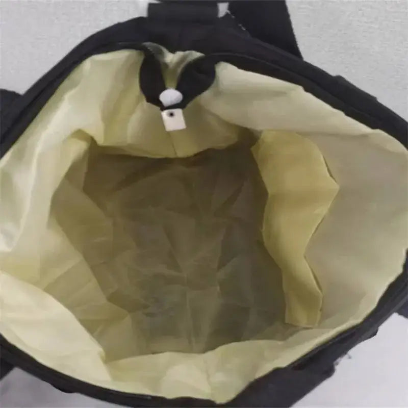 Interior view of a nylon crossbody messenger bag showing spacious compartment with soft lining