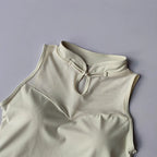 Elegant padded gym crop top in cream color featuring a stylish collar and mesh detailing