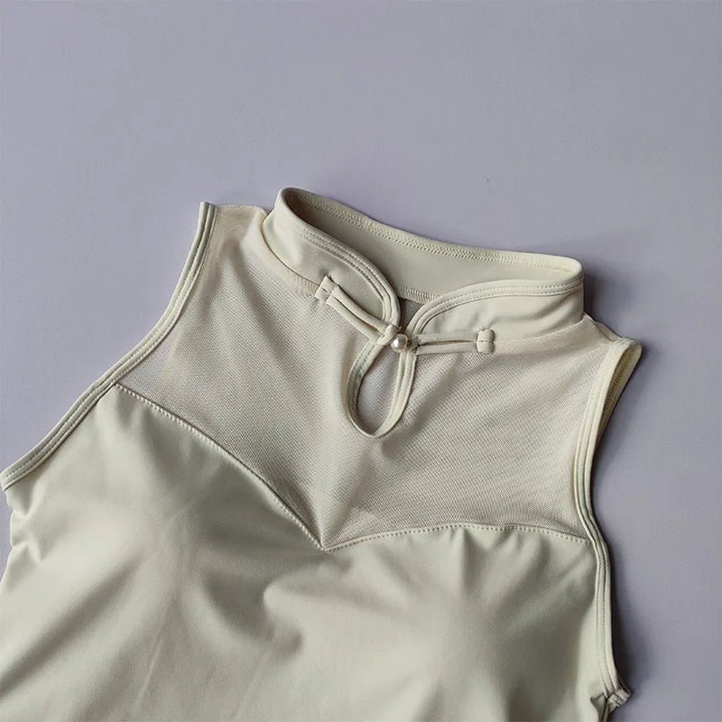 Elegant padded gym crop top in cream color featuring a stylish collar and mesh detailing