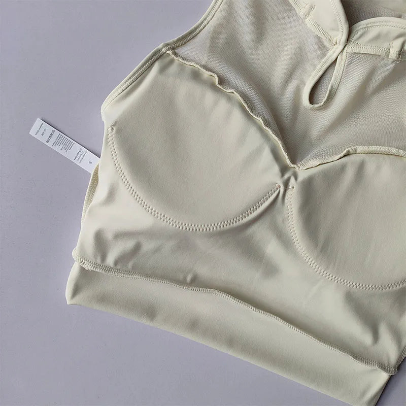 Light beige padded gym crop top with a stylish design for comfortable workouts