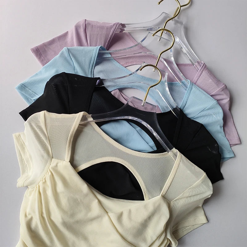 Collection of padded yoga shirts for women in various colors hanging on display