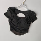 Elegant black padded yoga shirts for women featuring a stylish open back design