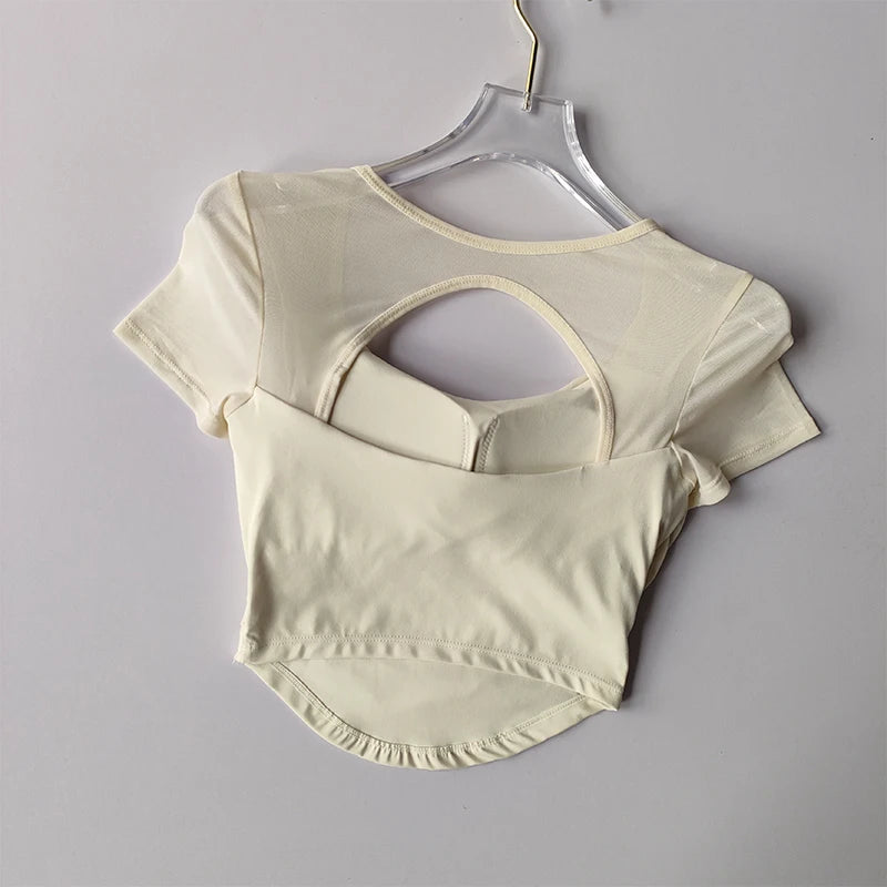 Cream-colored padded yoga shirts for women with a stylish back cutout design