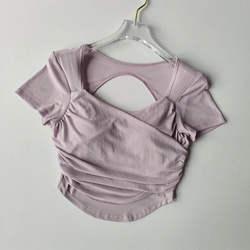 Padded yoga shirts for women in soft lilac fabric with stylish back design