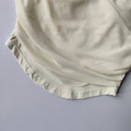 Cream colored padded yoga shirts for women with soft fabric and comfortable fit