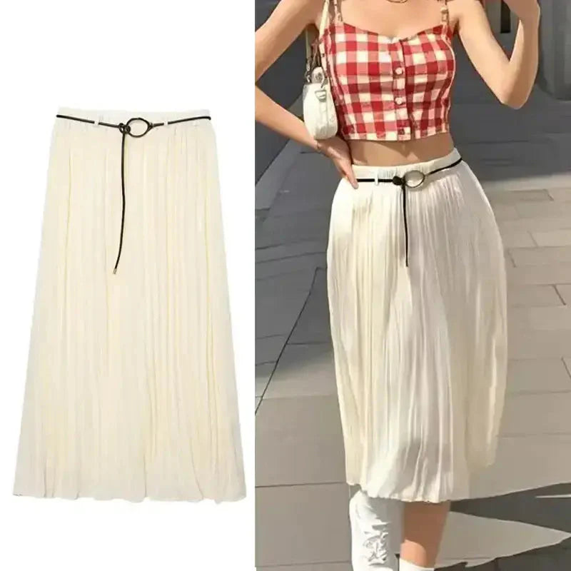 White pleated chiffon midi skirt with black belt detail styled with red checkered crop top