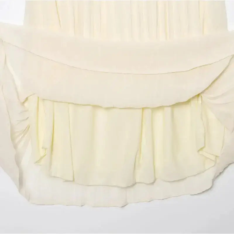 Cream pleated chiffon midi skirt detail showing layered and flowing fabric design