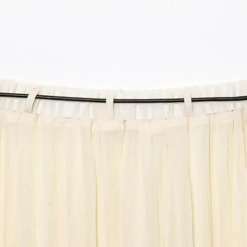 Close-up of cream pleated chiffon midi skirt waistband with belt loops from The Lady's Haven Boutique