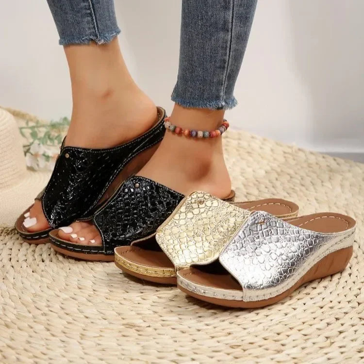Plus size gladiator sandals in black, gold, and silver with textured straps and wedge soles