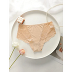 Beige plus size lace underwear for women with floral lace detail laid flat on white plate