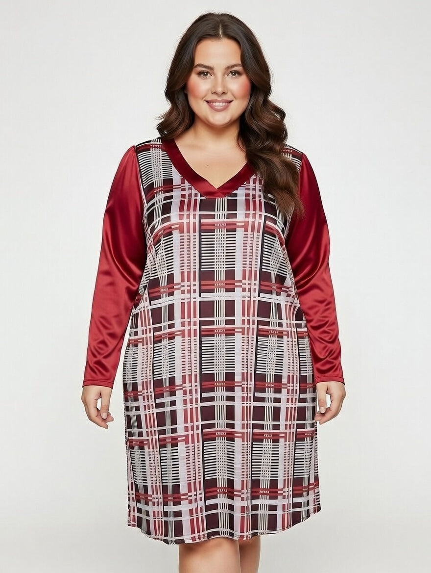 Plus-size woman smiling and wearing a stylish knee-length dress with a red, white, and brown plaid pattern, satin red long sleeves, and a V-neckline.