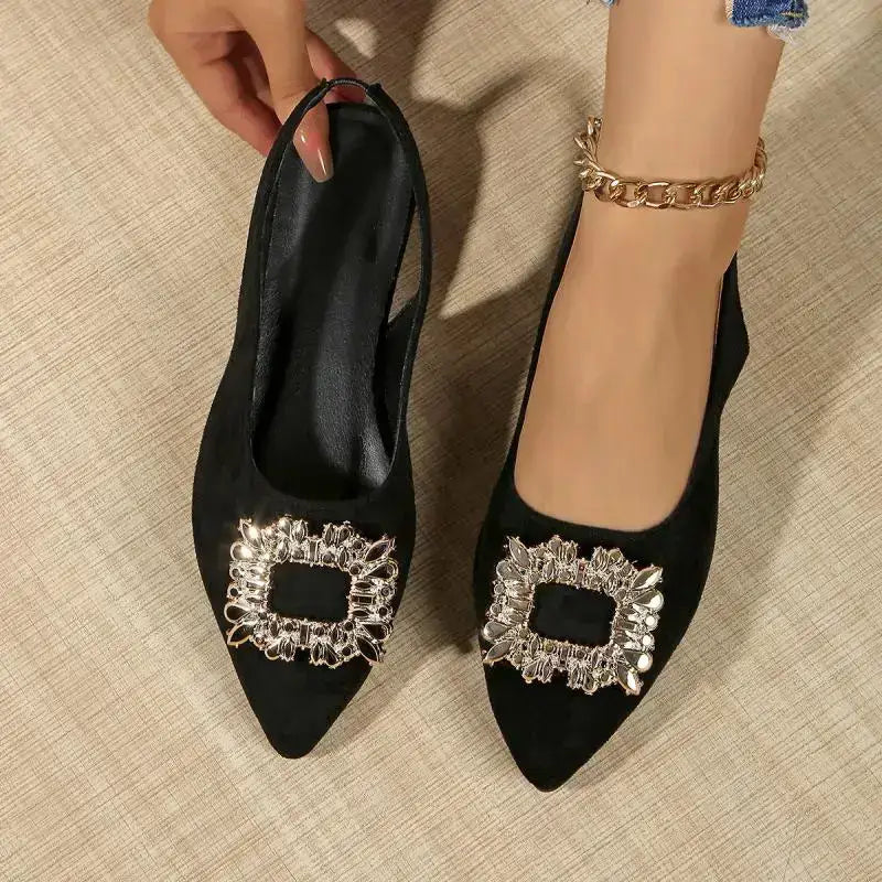 Black pointed toe crystal buckle sandals flat heel from The Lady's Haven Boutique worn on foot and held in hand