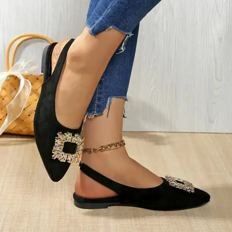 Black pointed toe crystal buckle sandals flat heel from The Lady's Haven Boutique worn with blue jeans
