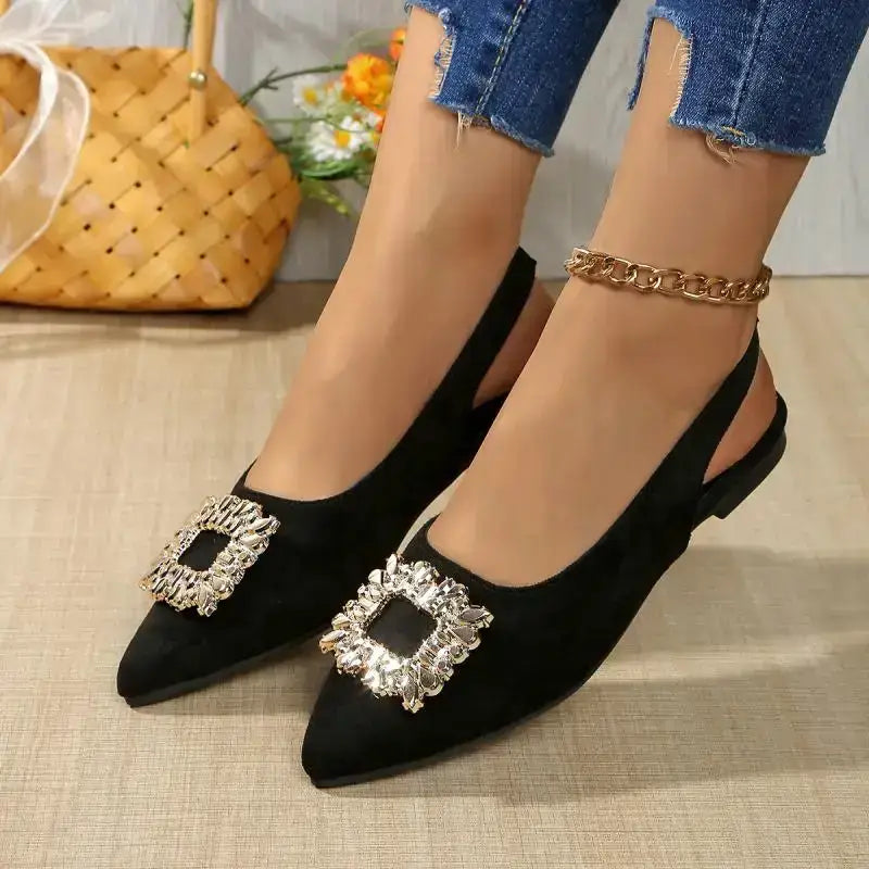 Black flat heel pointed toe crystal buckle sandals from The Lady's Haven Boutique worn with jeans