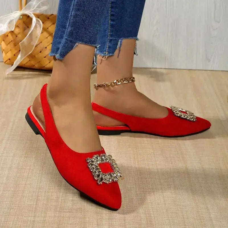 Red flat heel pointed toe crystal buckle sandals from The Lady's Haven Boutique worn with jeans