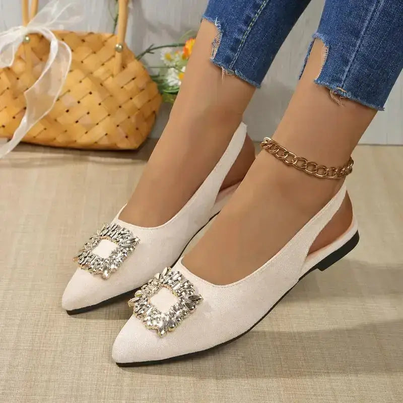 Pointed toe crystal buckle sandals in white with flat heels and slingback design from The Lady's Haven Boutique