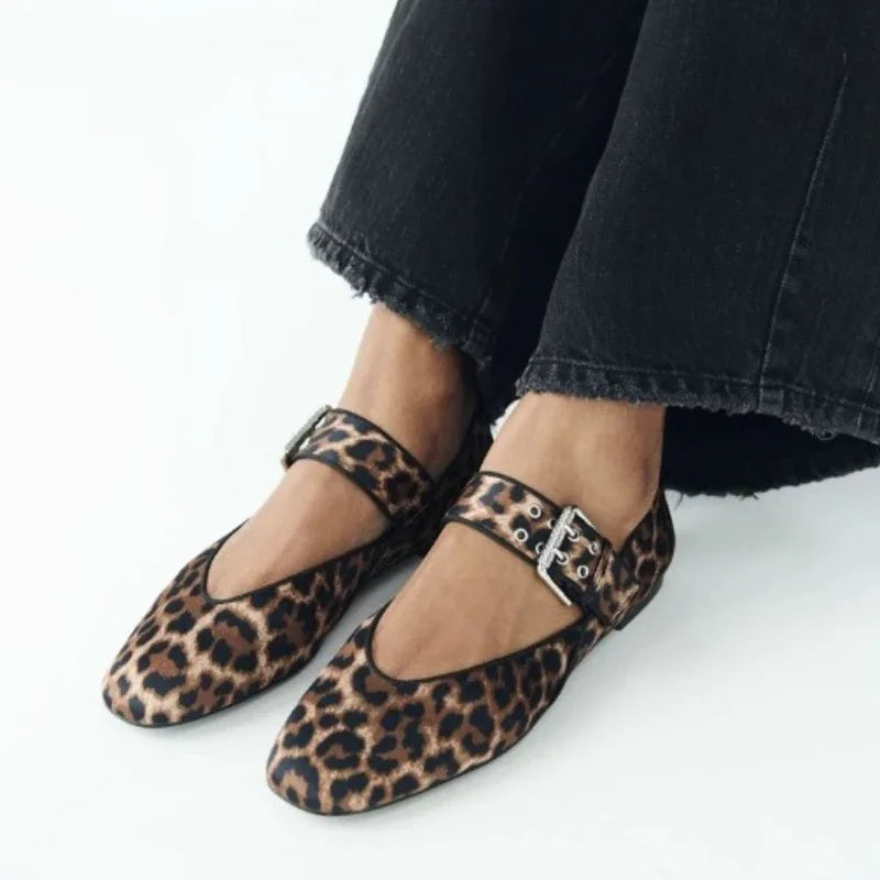 Leopard print pointed toe flats with ankle strap and buckle worn with black cropped jeans