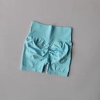 Light blue push-up gym shorts for women featuring a stylish ruched back design for a flattering fit