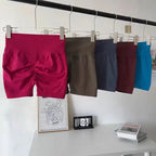 Variety of push-up gym shorts for women in multiple colors hanging on a rack for stylish workouts