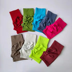 Variety of push-up gym shorts for women in multiple colors including red, green, blue, and pink