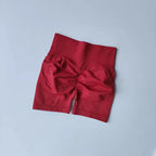 Red push-up gym shorts for women with a high waist and ruching detail for style and comfort
