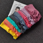 Colorful stack of push up leggings for women in various shades laid on a magazine backdrop