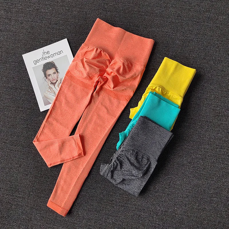 Colorful push up leggings for women in coral, blue, yellow, and gray laid out flat with a fashion magazine