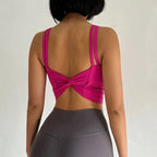 Stylish pink push up sports bras for women featuring a unique back design and adjustable straps