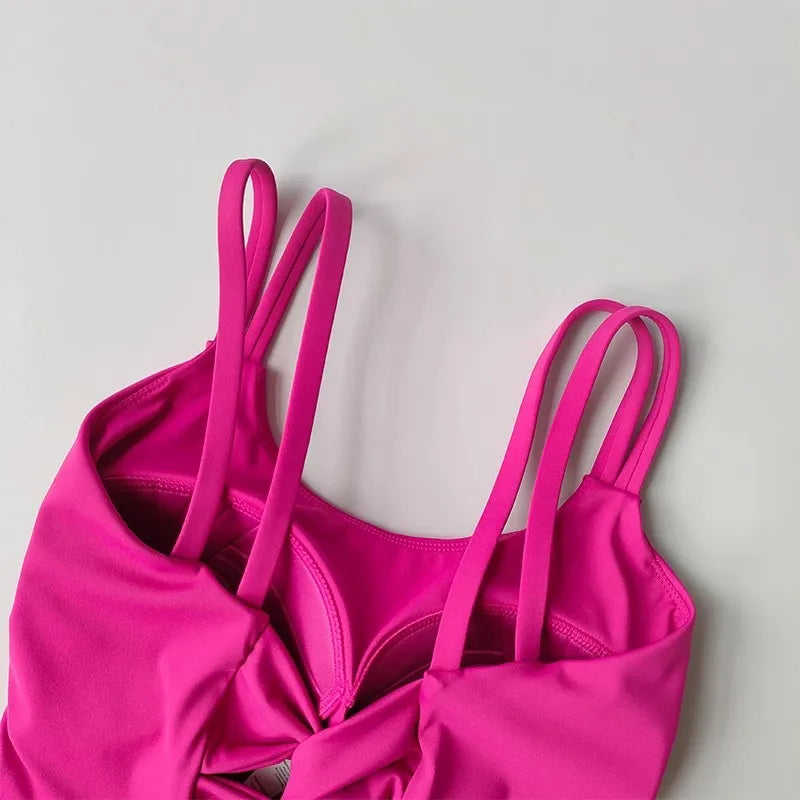 Vibrant pink push up sports bras for women with stylish straps and comfortable design
