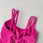 Vibrant pink push up sports bras for women with stylish straps and comfortable design