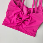 Bright pink push up sports bras for women with a stylish knotted front design
