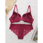The Lady's Haven Boutique burgundy lace push up underwire bra and panty set laid flat on white textured surface