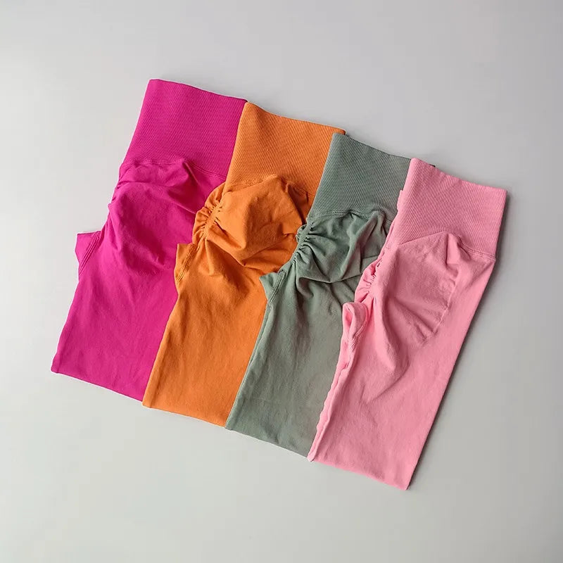 Brightly colored quick dry sport leggings in pink, orange, green, and light pink for active wearers