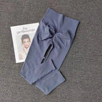 Quick dry sport leggings in grey color laid flat next to a fashion magazine for stylish workout wear
